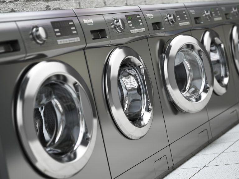 Row of washing machines in a public laundromat.